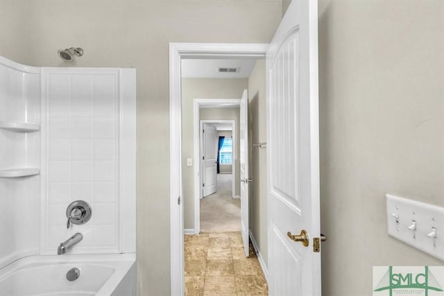 bathroom with visible vents,  shower combination, and baseboards