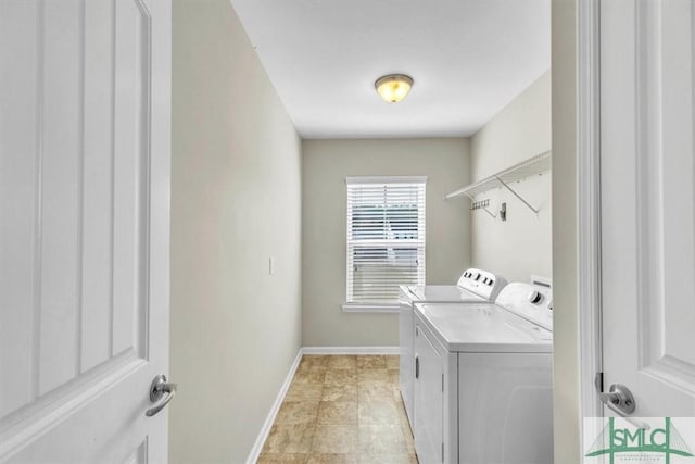laundry room featuring baseboards, laundry area, and washing machine and dryer