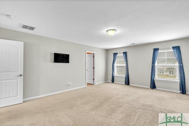 carpeted empty room with baseboards and visible vents