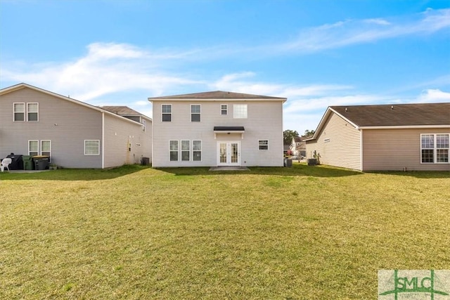 rear view of house featuring french doors, central air condition unit, and a yard