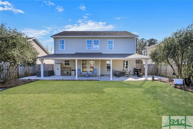 rear view of property with a patio area, a fenced backyard, and a yard