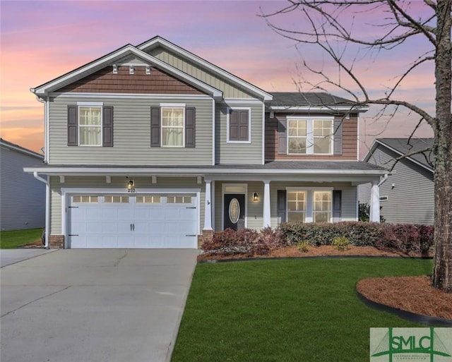 craftsman inspired home featuring a garage, concrete driveway, and a lawn