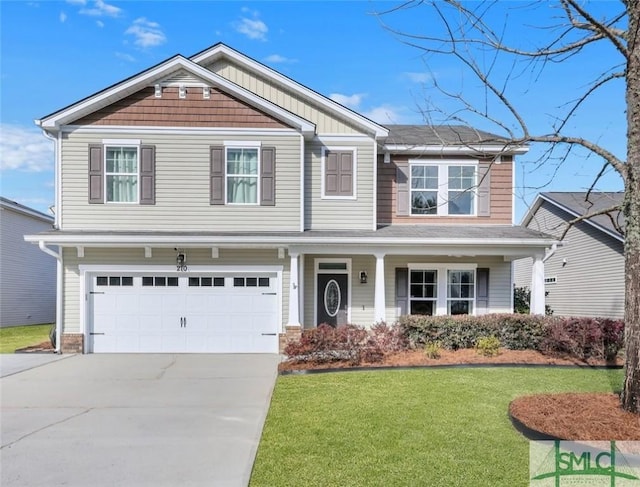 craftsman-style home featuring covered porch, concrete driveway, a front lawn, and an attached garage