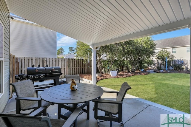 view of patio with outdoor dining area, grilling area, and a fenced backyard