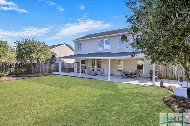 rear view of house featuring a patio area, a fenced backyard, and a lawn