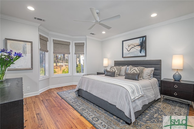 bedroom with crown molding, recessed lighting, visible vents, wood finished floors, and baseboards