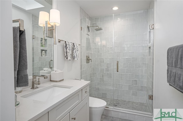 full bath with toilet, a shower stall, and vanity