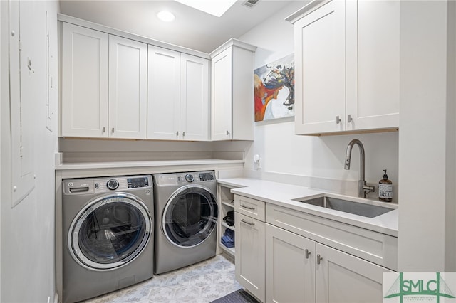 laundry room with washer and dryer, cabinet space, a sink, and recessed lighting