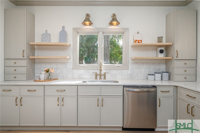 kitchen featuring light stone counters, a sink, stainless steel dishwasher, decorative backsplash, and open shelves