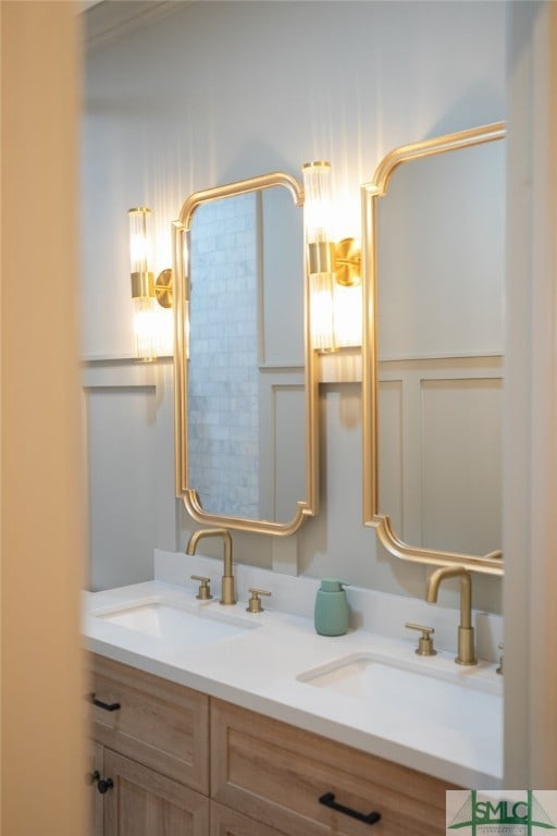 bathroom featuring a sink and double vanity