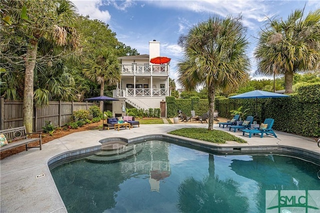 view of pool featuring a fenced in pool, a patio, fence, and stairs