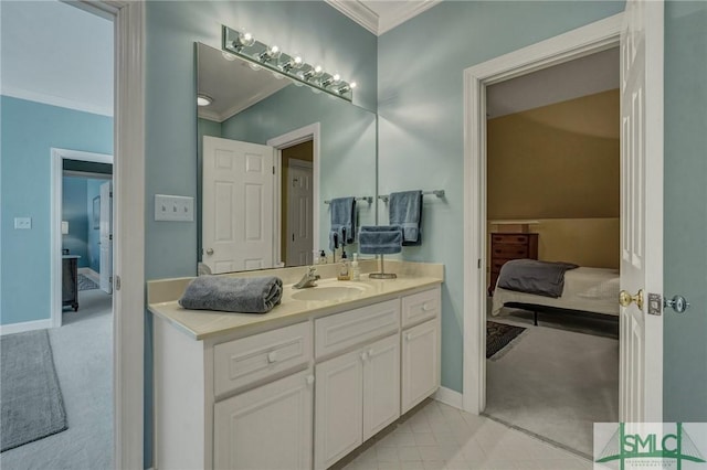 bathroom with baseboards, crown molding, vanity, and ensuite bath