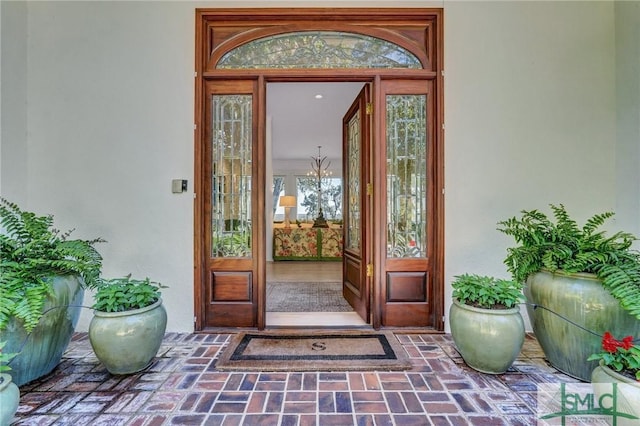 doorway to property featuring stucco siding