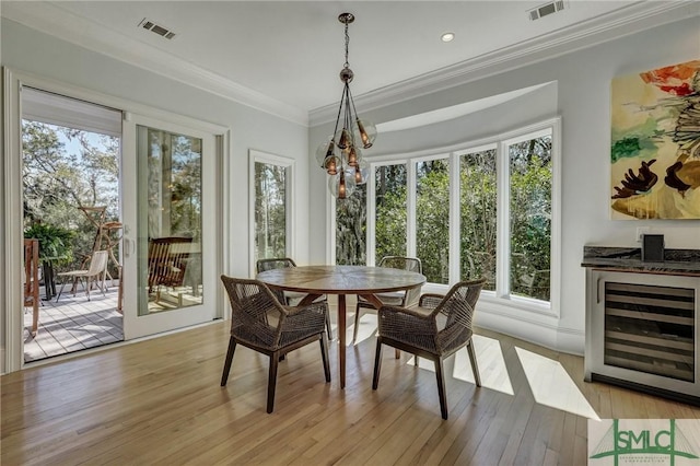 dining space with a wealth of natural light, beverage cooler, and visible vents