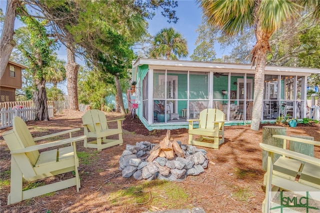 back of house featuring a sunroom and fence