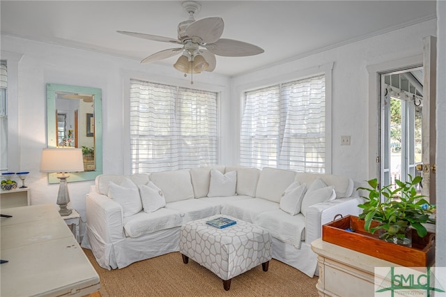 living area with crown molding and ceiling fan