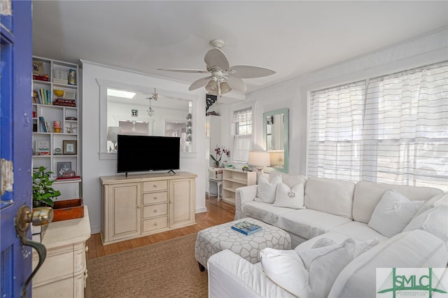 living area featuring light wood-style floors and ceiling fan