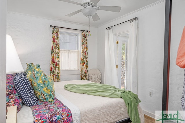 bedroom featuring ornamental molding, multiple windows, and a ceiling fan