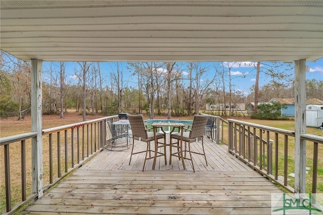 wooden terrace featuring outdoor dining space