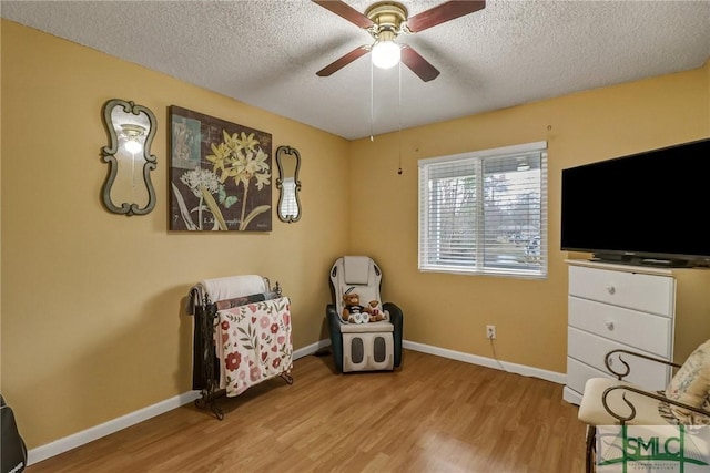 sitting room with light wood-style flooring and baseboards