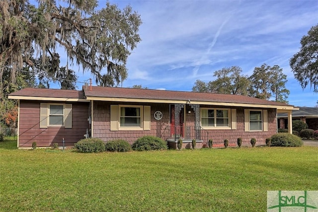 ranch-style house featuring a front yard and covered porch