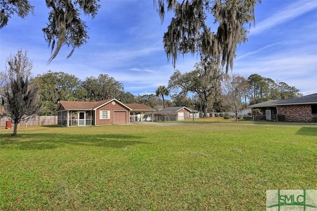 view of yard with an attached garage and fence