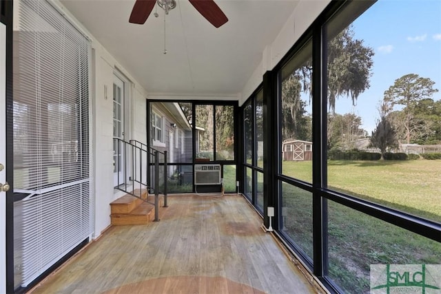 unfurnished sunroom with a ceiling fan