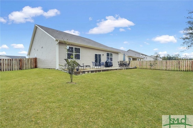 rear view of property with a fenced backyard, a patio, and a yard