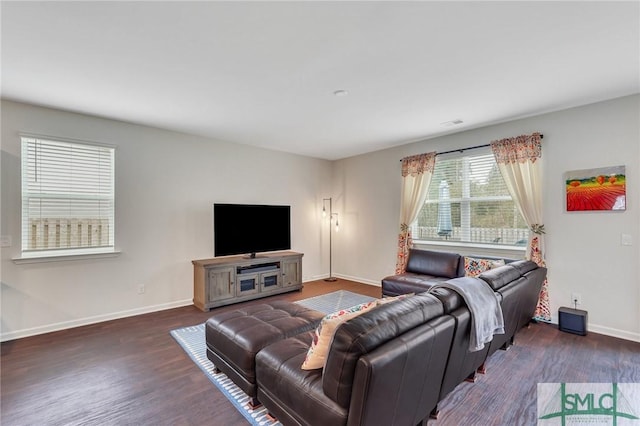 living room featuring dark wood-style floors, visible vents, and baseboards