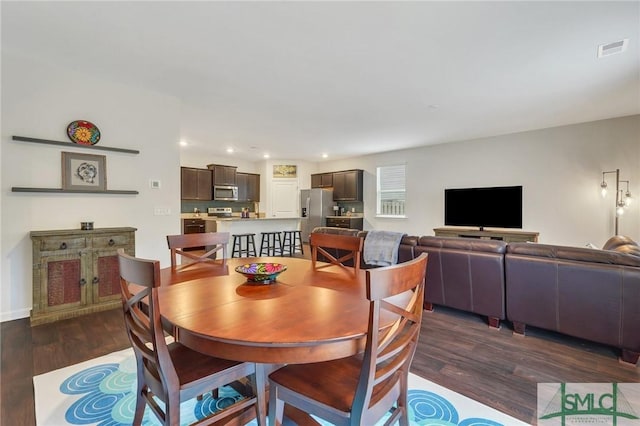 dining space with visible vents, dark wood finished floors, and recessed lighting