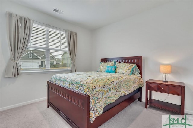 carpeted bedroom featuring baseboards and visible vents