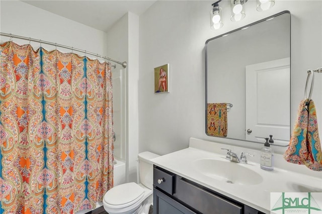 bathroom with toilet, shower / tub combo, and vanity