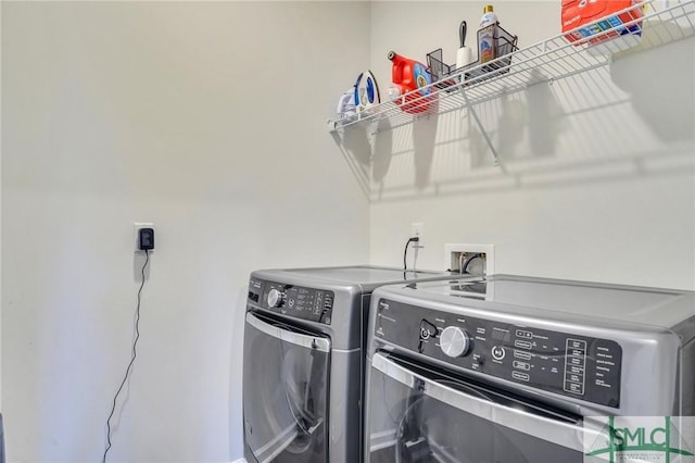 clothes washing area featuring laundry area and separate washer and dryer