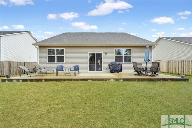 back of property featuring fence, a patio, and a yard