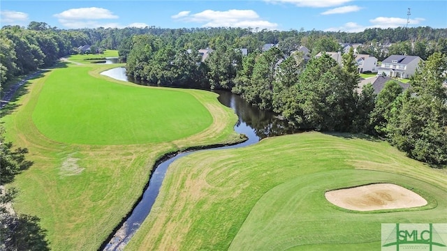 drone / aerial view with view of golf course and a water view