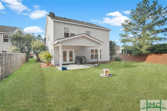 back of house with a patio area, a fenced backyard, a lawn, and french doors