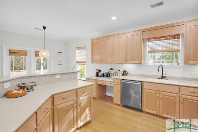 kitchen featuring light brown cabinets, a sink, visible vents, light countertops, and stainless steel dishwasher