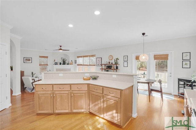 kitchen featuring light countertops, light wood finished floors, and a healthy amount of sunlight