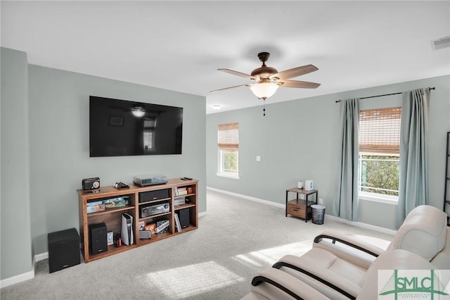 living room featuring carpet floors, visible vents, ceiling fan, and baseboards