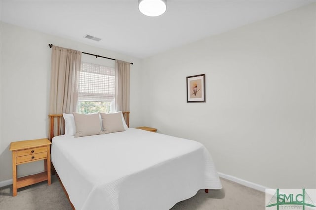 bedroom featuring light colored carpet, visible vents, and baseboards