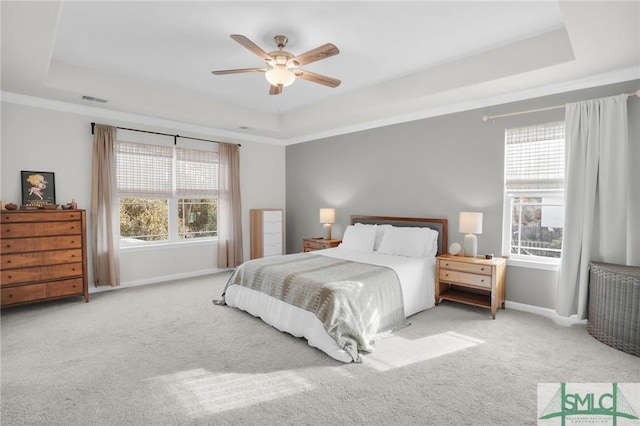 bedroom with visible vents, a raised ceiling, and carpet flooring