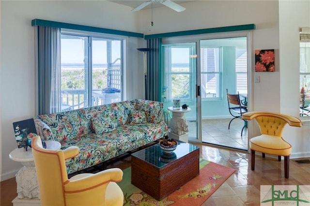 living area featuring visible vents, ceiling fan, and baseboards