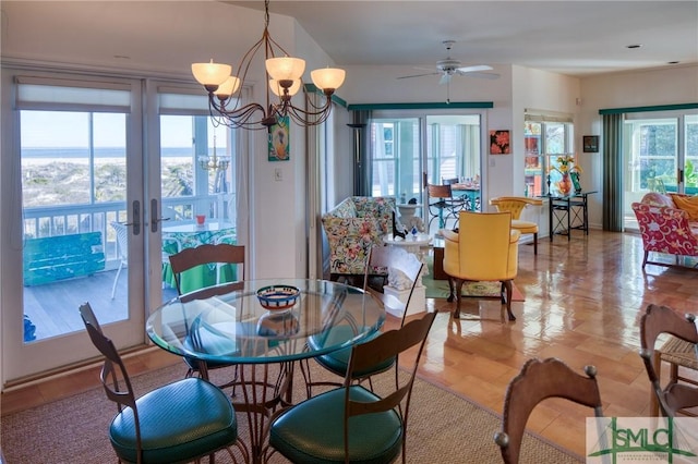 dining area featuring ceiling fan with notable chandelier