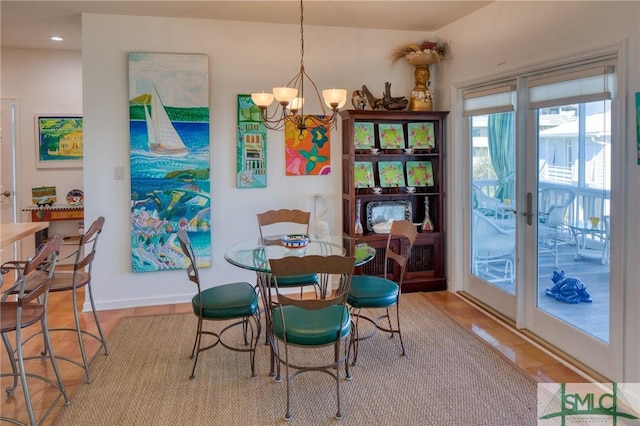 dining space with baseboards and an inviting chandelier