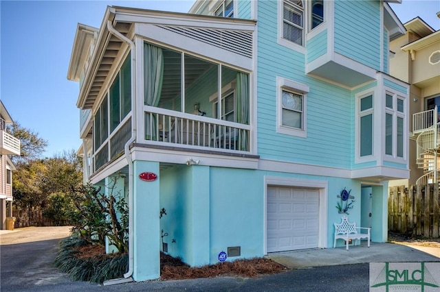 exterior space featuring an attached garage and stucco siding