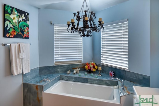 full bath featuring a bath and a notable chandelier