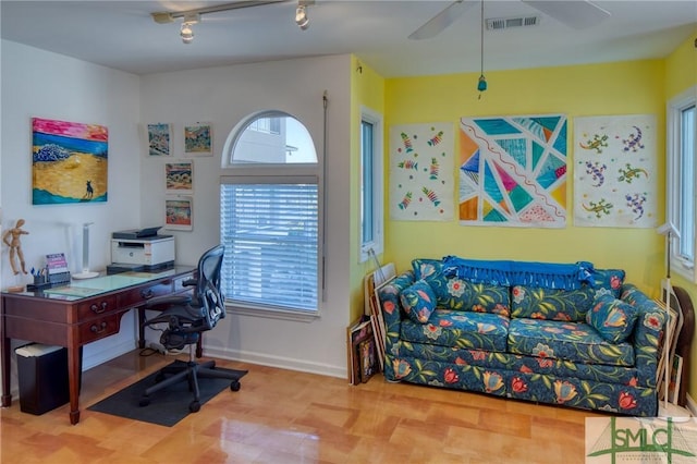 office area featuring a ceiling fan, baseboards, visible vents, and track lighting