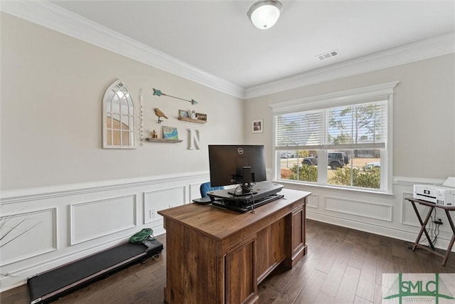 office area with a wainscoted wall, visible vents, dark wood finished floors, and crown molding