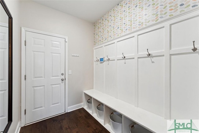 mudroom with dark wood-style flooring and baseboards