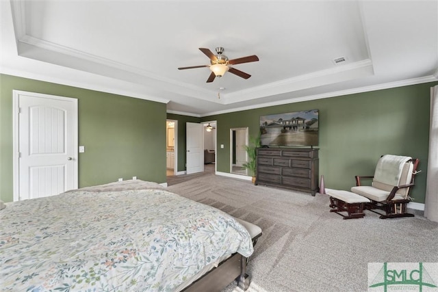 carpeted bedroom featuring ceiling fan, visible vents, baseboards, a raised ceiling, and crown molding